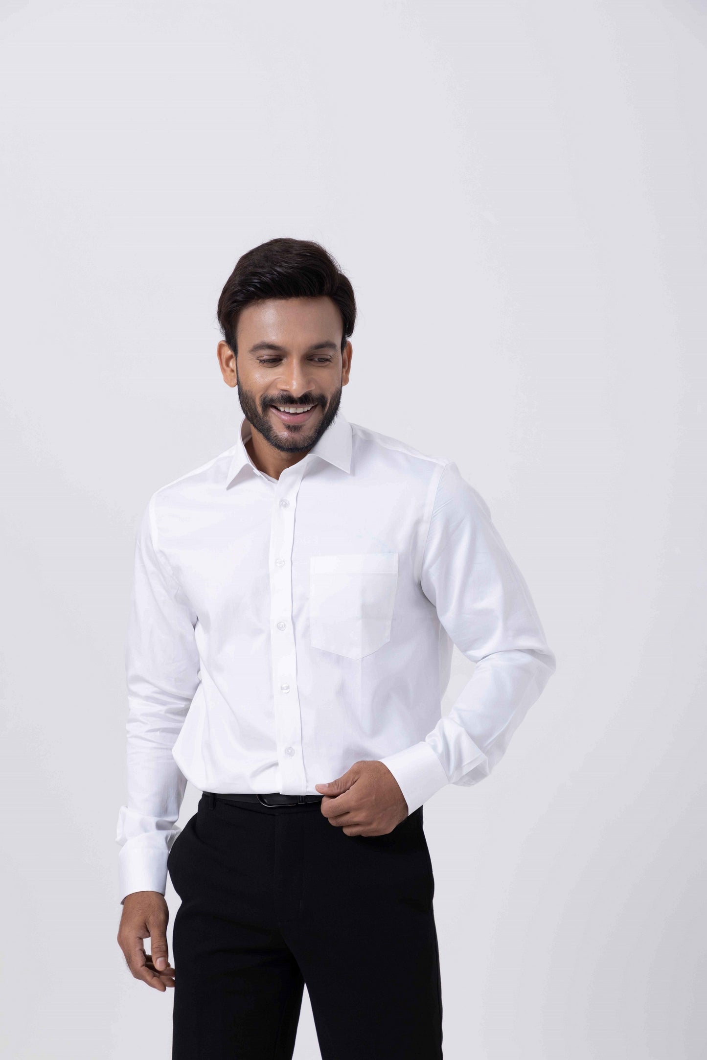 Man smiling in a Classic Giza White Regular Shirt by Tailors Cove, showcasing refined elegance and comfort.