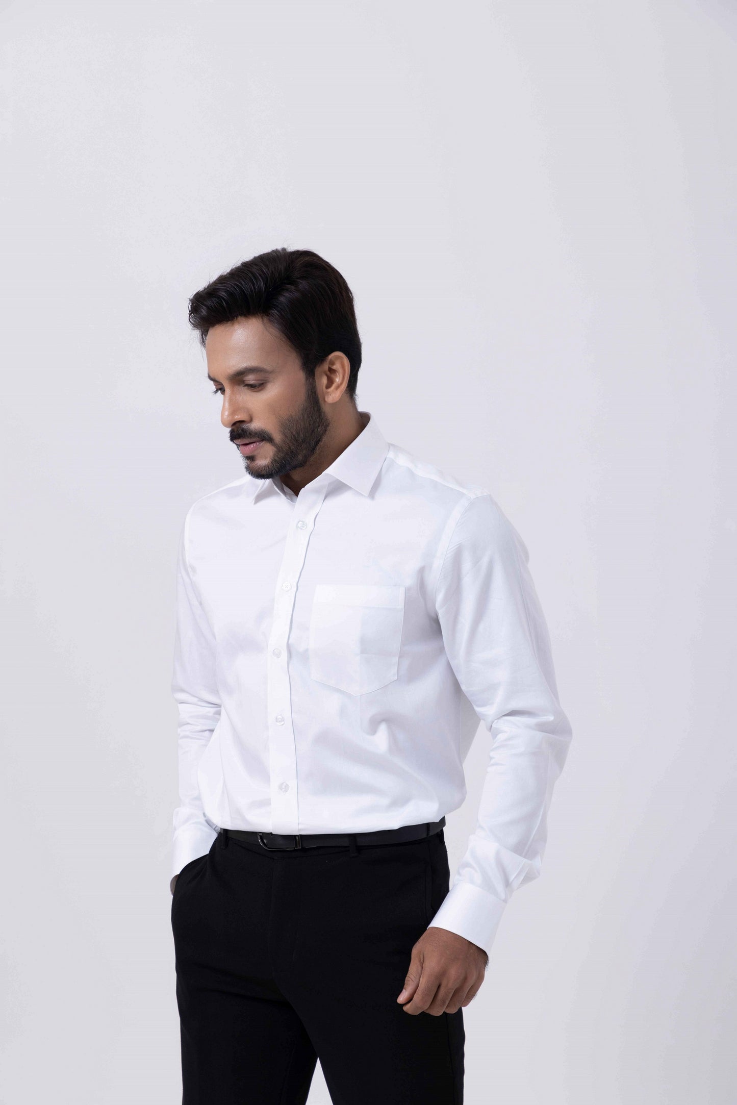Man wearing a Classic Giza White Regular Shirt by Tailors Cove, showcasing its elegant style and tailored design.