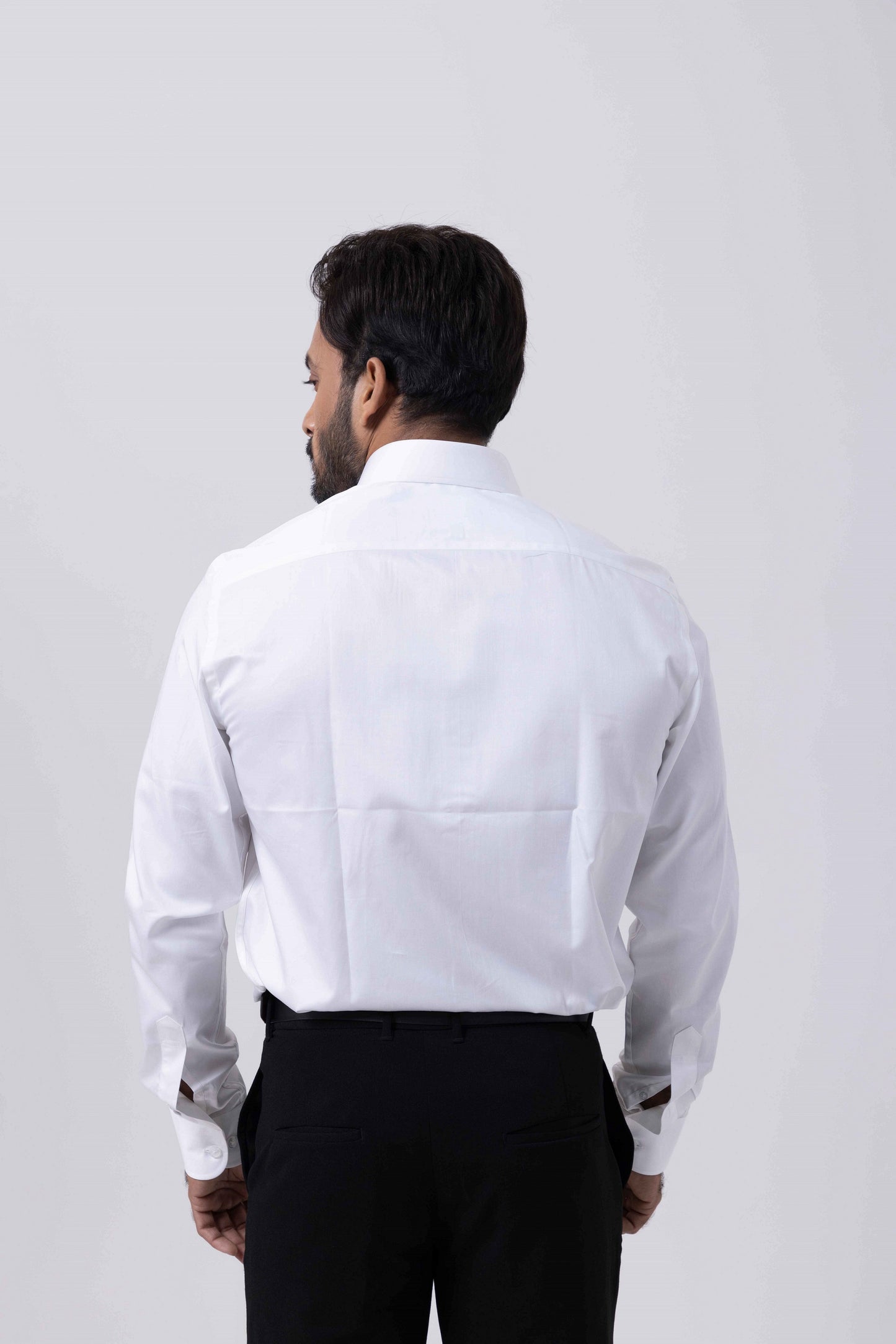 Back view of a man wearing the Classic Giza White Regular Shirt by Tailors Cove, showcasing its tailored design.