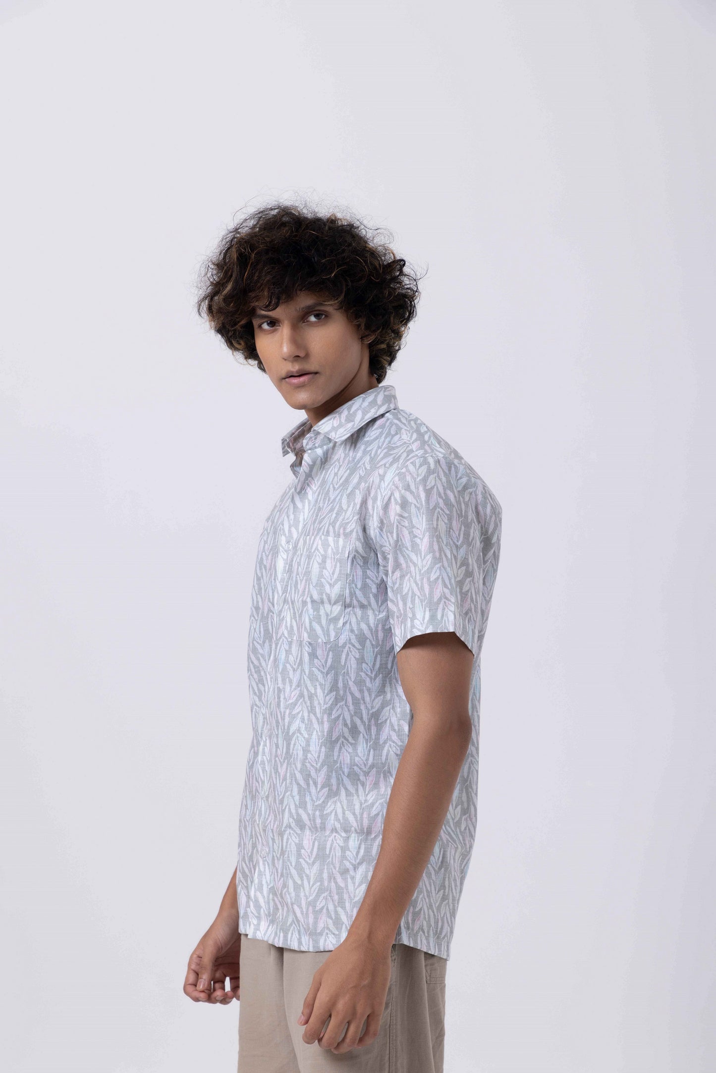 Man wearing a Leaf Print Down Collar Slim Fit Shirt in Melange, showcasing a casual and stylish design.