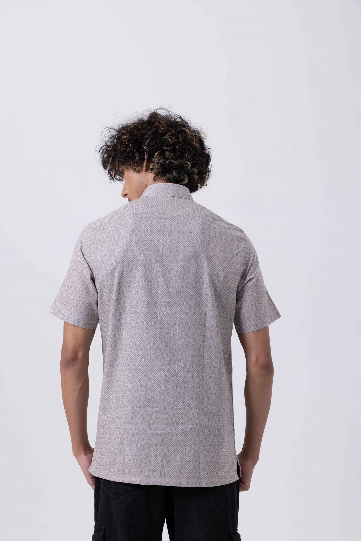 Back view of a men's printed half sleeve shirt in subtle melange fabric, showcasing a modern slim fit design.