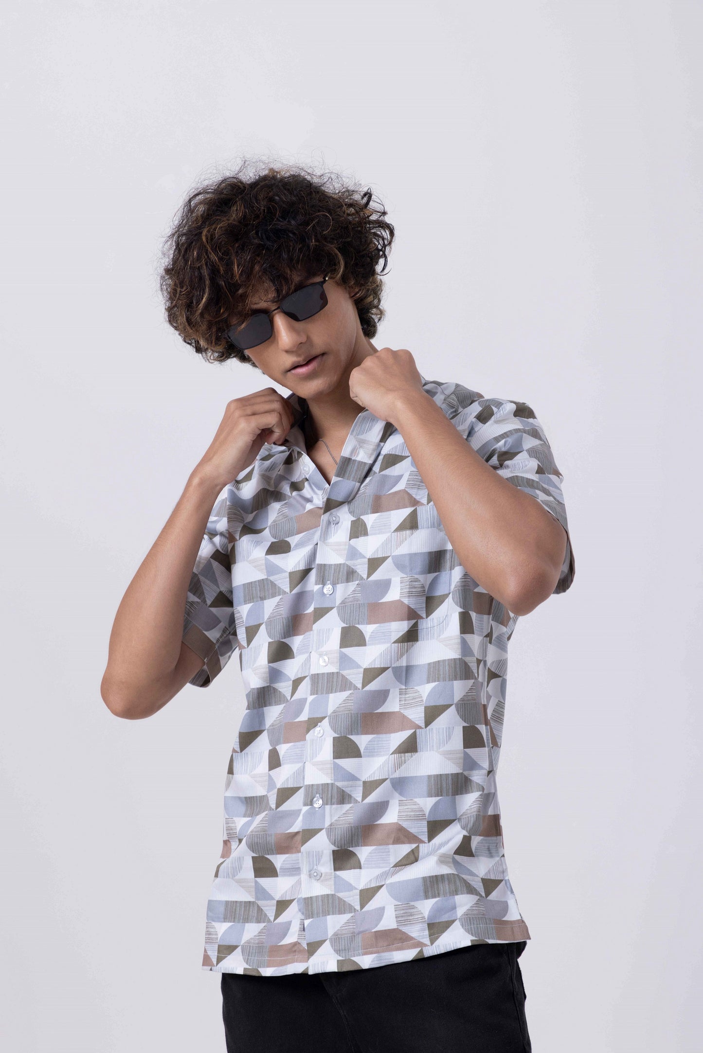 Man wearing The Man Printed Slim Fit Shirt with geometric prints, showcasing stylish design and contemporary appeal.