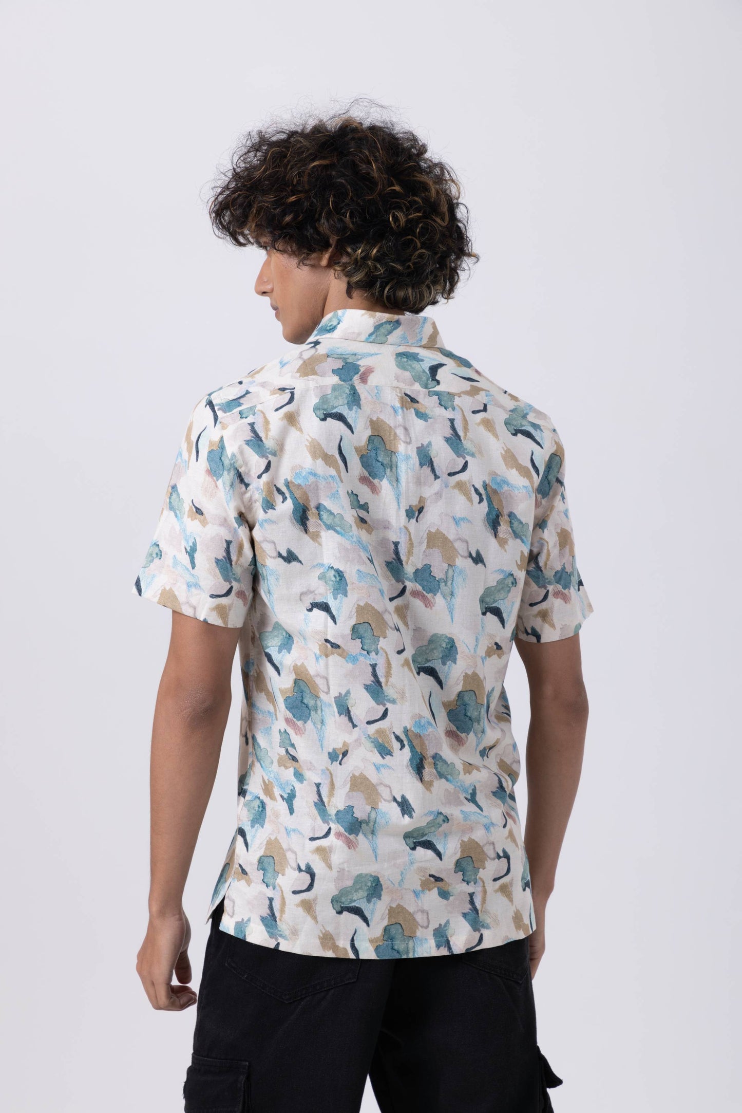 Back view of a man wearing a Tropical Print Slim Fit Shirt made from Belzona linen, featuring vibrant patterns.