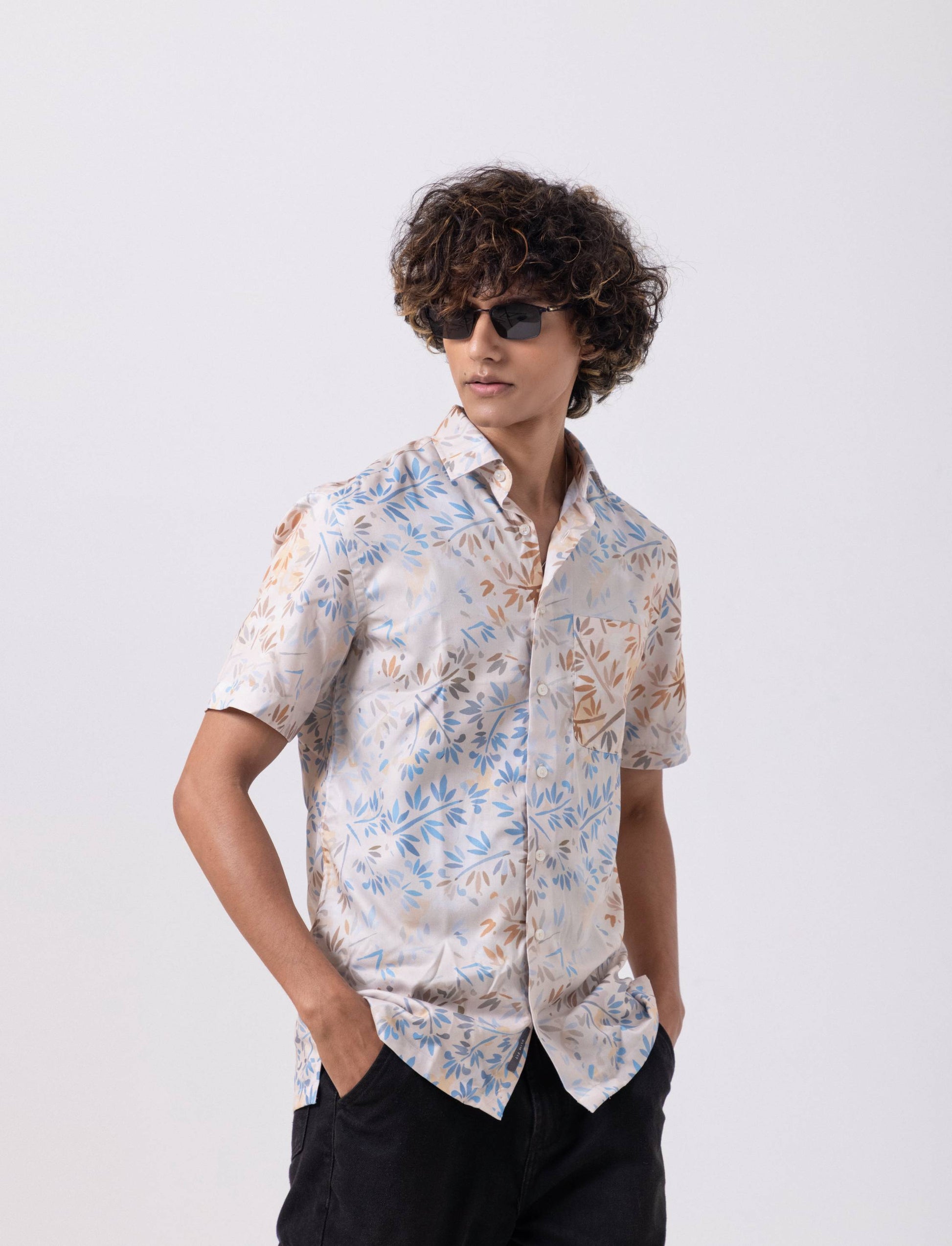 Model wearing Leaf Printed Satin Slim Fit Shirt, showcasing elegant design and modern style with sunglasses.