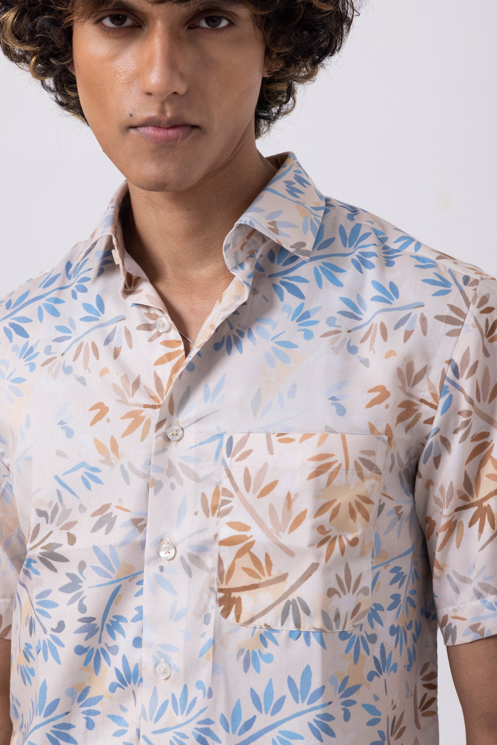 Leaf printed satin slim fit shirt for men, featuring blue and brown delicate leaf patterns, stylish and modern design.