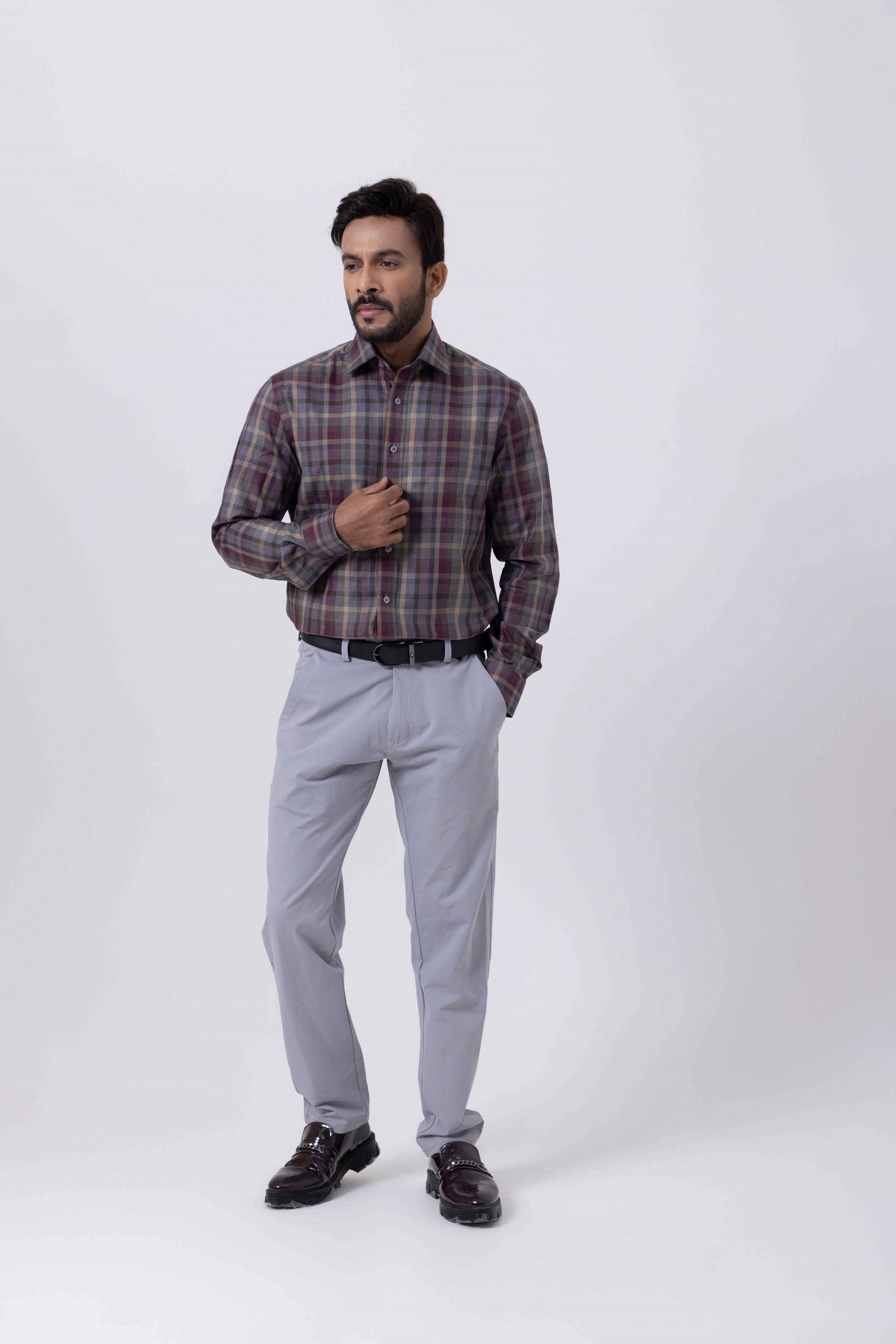 Man wearing a violet checkered regular fit Giza cotton shirt paired with grey pants and black shoes.