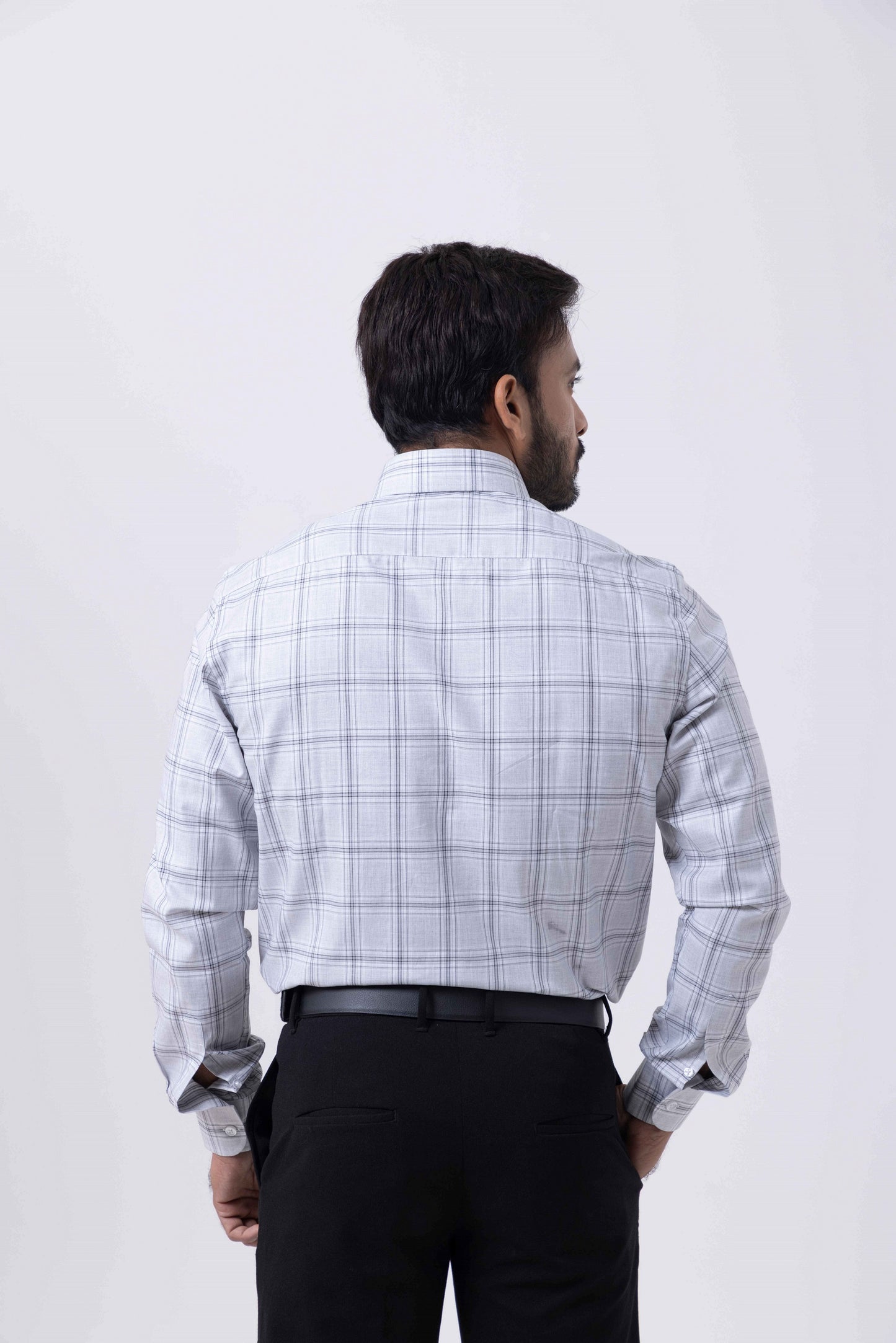 Back view of a man wearing the Giza Classic Black and White Checked Regular Fit Shirt by Tailors Cove.