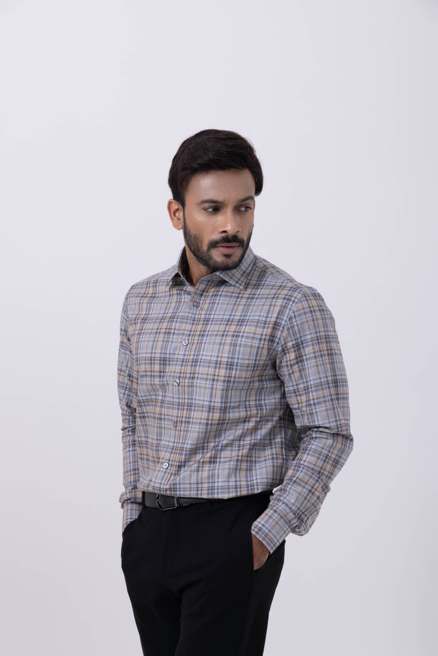 Man in a gray and orange checked regular fit shirt, showcasing modern men's fashion style with confidence.