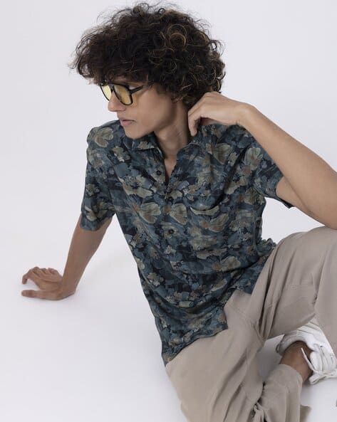 Men's jungle print half-sleeve shirt in teal, showcasing modern fashion and a comfortable fit.