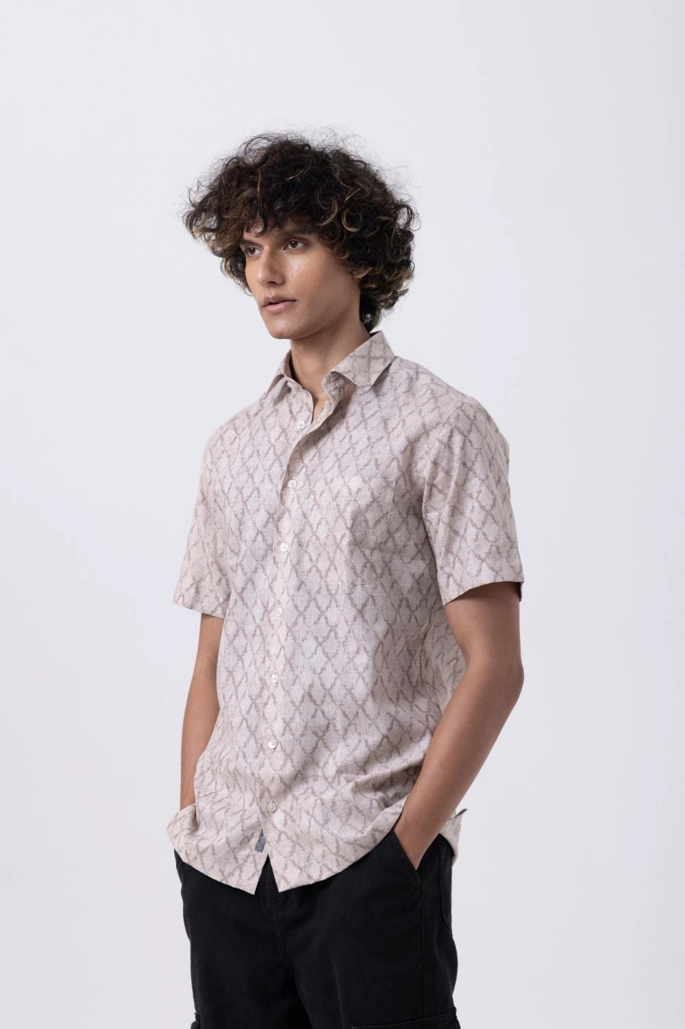Model wearing a refined Down Collar Slim Fit Shirt in melange with a stylish geometric pattern.