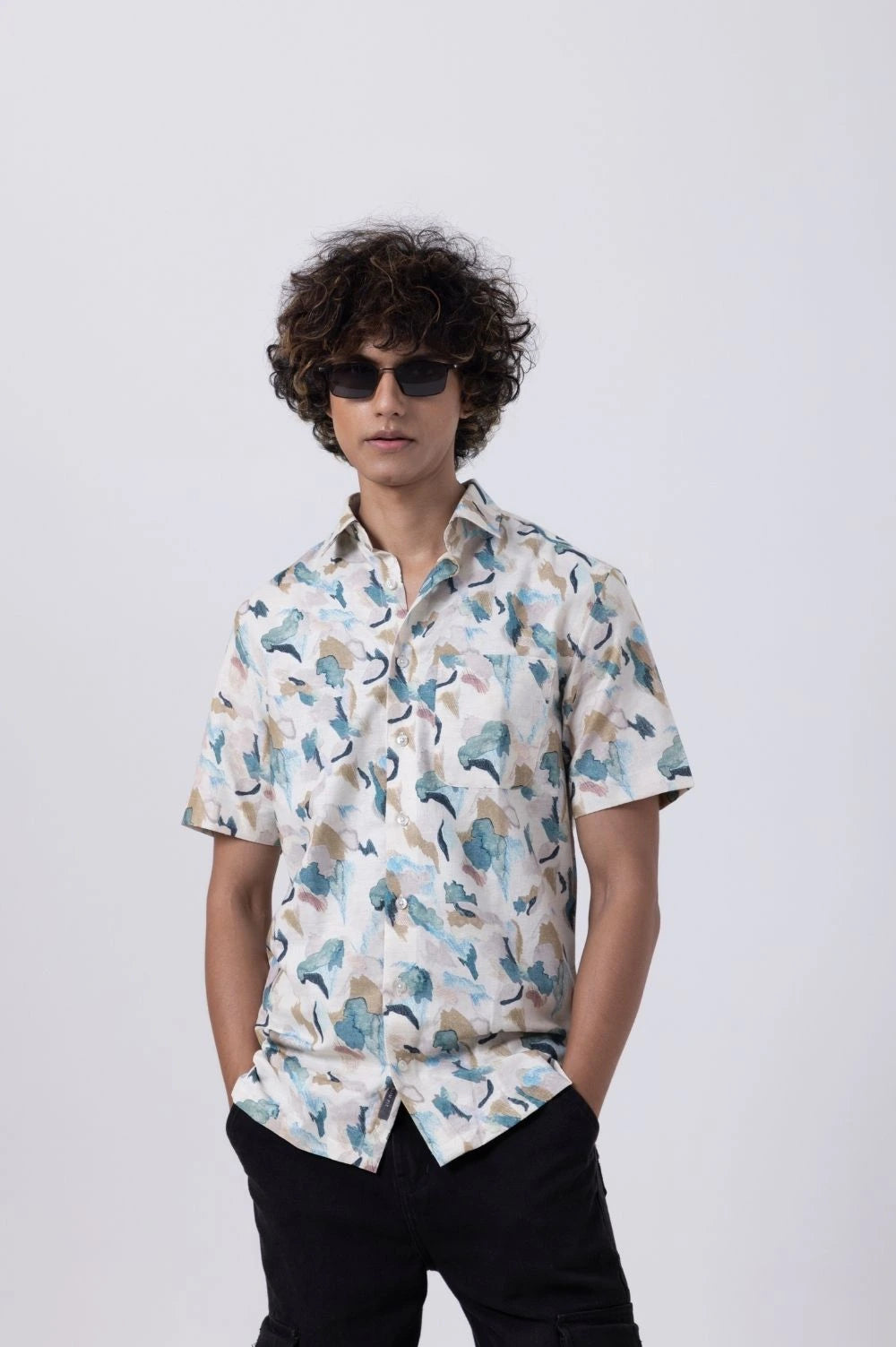 Model wearing a tropical print slim fit shirt for men, showcasing vibrant patterns and a modern silhouette.