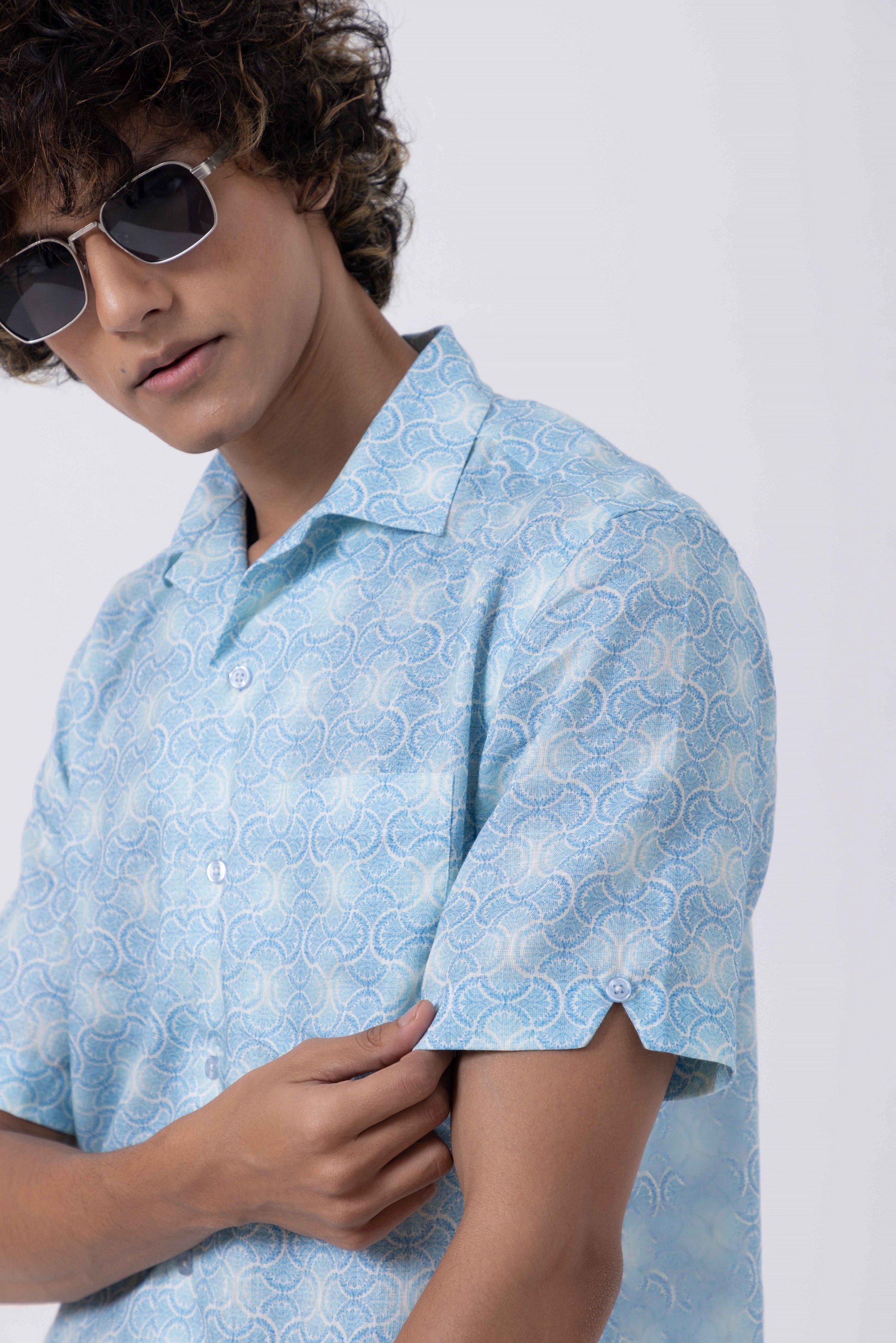 Model wearing Vintage Print Open Collar Regular Fit Shirt in light blue, showcasing a relaxed yet stylish look for men.